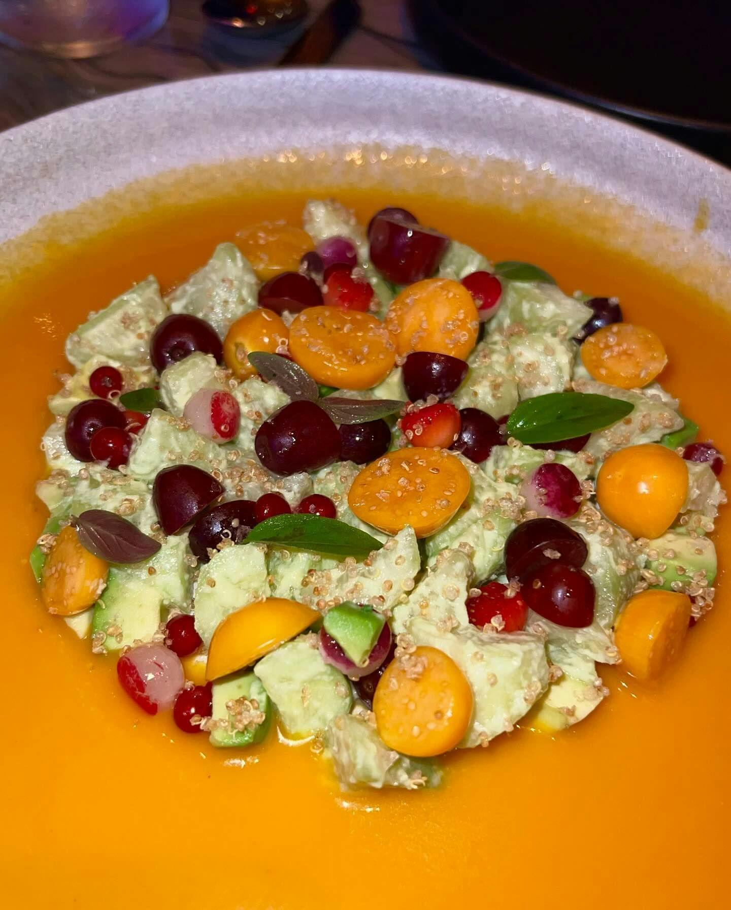 A vibrant salad featuring a medley of fresh fruits, vegetables, and quinoa artistically presented in a bowl, showcasing the type of healthy, gourmet dishes available through Booked in New York's best restaurants.